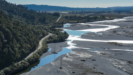 Surrounded by mountain ranges the Turiwhate River flows through farming fields on the road to Arthurs Pass