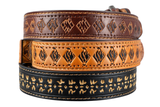 Three intricately embossed leather dog collars in brown, tan, and black, stacked on a transparent background. background removed
