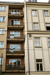 There is a prominent building featuring a clock situated prominently on its side, showcasing time to all who pass by