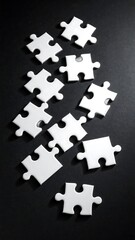 Naklejka premium White jigsaw puzzle pieces scattered on a dark background, showcasing a fragmented and incomplete image.