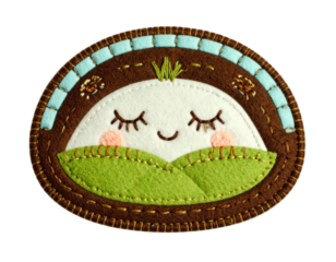 Handcrafted Felt Patch with Sleeping Face and Green Hills Landscape.