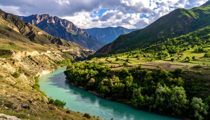 Fototapeta premium A serene mountain valley, showcasing a winding river snaking through verdant landscapes and terraced fields under a partly cloudy sky.