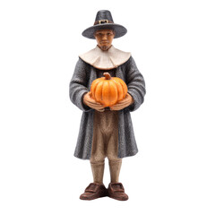 A figurine of a Pilgrim man holding a pumpkin, a Thanksgiving symbol. background removed