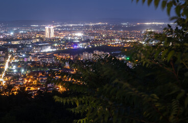 night view of a european city from a hill, with city lights, buildings, and a clear night sky. taken in skopje, macedonia