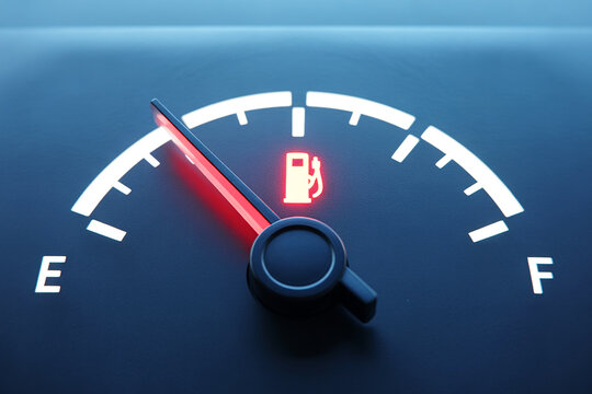 Car fuel gauge shows empty tank with red warning light