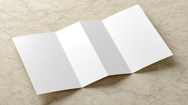 Blank tri-fold brochure on light beige marble