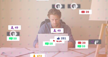 Typing man wearing shirt at office desk, with silver laptop notebook papers notification overlays