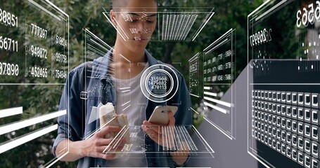 Holding smartphone and snack, denim-clad man using AR interface in park with holographic panels