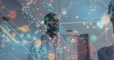 Projecting holographic circuitry overlay hovering above table in meeting room, coworkers gesturing