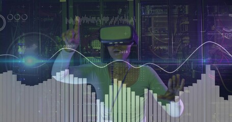 Mid adult woman wearing VR headset manipulating holograms in server room with blinking LED lights