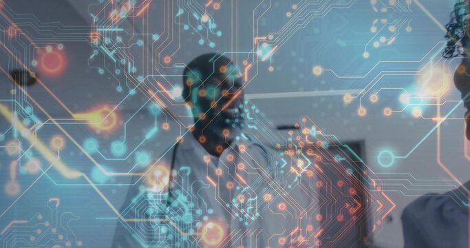 Projecting holographic circuitry overlay hovering above table in meeting room, coworkers gesturing