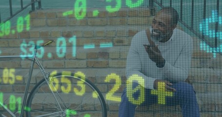 Sitting man speaking into smartphone on outdoor brick steps by bicycle with financial data overlay