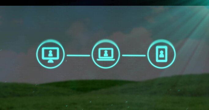 Fototapeta Floating three neon device icons connecting with glowing lines over grassy hill in digital sky