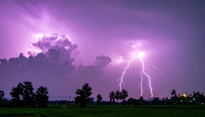 Powerful lightning strikes a purple sky over a field