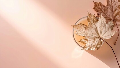 Dried Maple Leaves and Peach Beige Tea on Soft Background