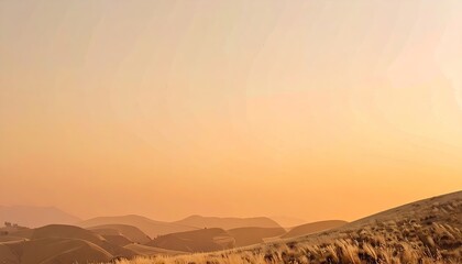 Obraz premium Orange and Yellow Sunset Over Rolling Hills