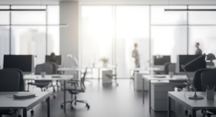 Blurred minimalist office setting with workstations and bright sunlight