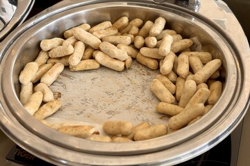 A Closeup View of Cooked Snacks Presented Beautifully in a Serving Tray for Enjoyment. A beautifully arranged tray of delightful snacks is now partially empty, ideal for food photography