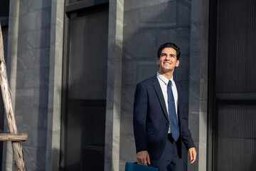 Confident young professional walking along a busy city street in the financial district, showcasing modern corporate attire and the daily work routine of an ambitious businessman in the city