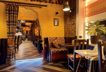 A stylish restaurant. A table and chairs with a beautiful interior and decoration for meals in a cozy family company