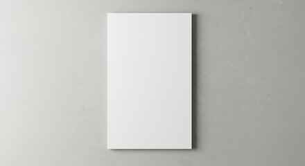 Blank white canvas hanging on a textured gray wall, ready for artwork.