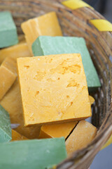 Colorful handmade soaps in a woven basket display