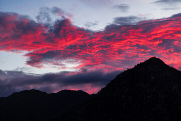 nubes rojas sobre silueta de monta&ntilde;a