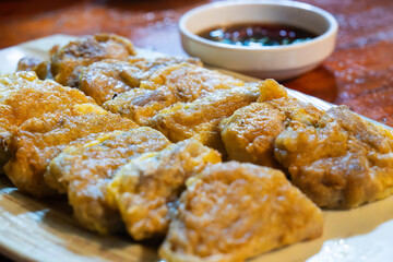 slices of fried fermented skate with soy sauce