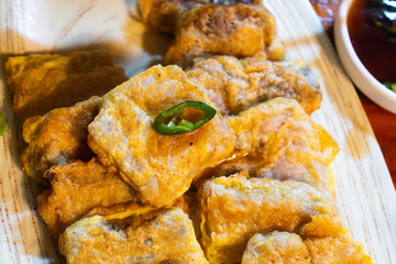 a slice of fried skate with chili pepper
