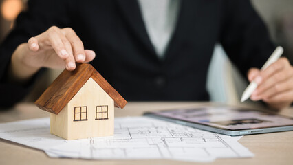 Real Estate Investment Planning with House Model on Blueprints – Property Finance and Mortgage Concept