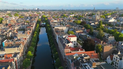 Stunning aerial footage beautifully showcases the picturesque canals of Amsterdam alongside its iconic, historic architecture, highlighting the vibrant neighborhoods of the city in remarkable detail