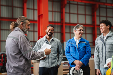 Fototapeta premium Team engineers and foreman gather for a meeting at the factory machines. Industry workers join together for collaboration and success.