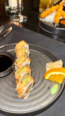 Close-up of a person using chopsticks to pick japanese food at sushi bar Sushi sashimi set Spicy tuna sushi roll topped with crispy flakes and drizzled with sauce