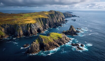 Rugged coastline with dramatic cliffs and emerald hills meet a stormy ocean