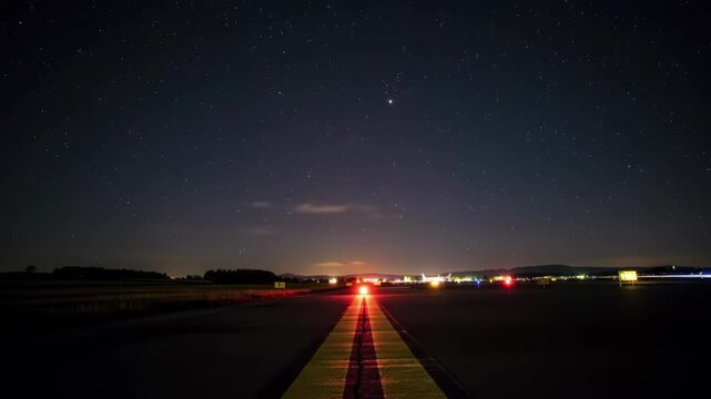 Stunning runway lights guide planes under a starry night sky, promising journeys ahead.