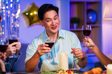 Happy friends celebrate together at home party, clinking wine glasses and sharing delicious food. The joyful moment reflects lifestyle, friendship, laughter, festive celebration in warm and colorful