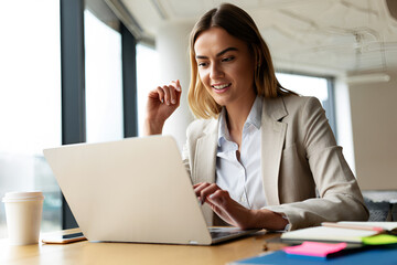 Woman working on laptop at desk office computer