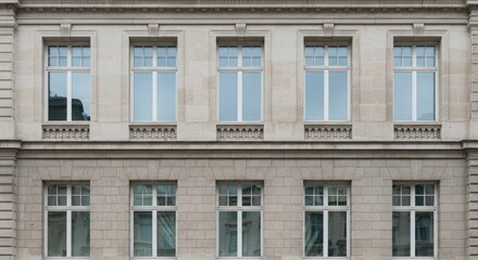 Obraz premium Close-up of a building facade with multiple windows and stone masonry