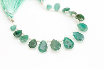 Natural Emerald Briolette Gemstones Closeup on White