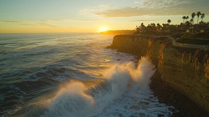 Waves crashing against a cliffside, creating a dramatic scene at sunset.