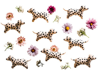 Collection of dalmatian dog figurines and assorted flowers isolated on transparent background
