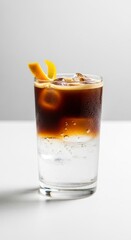 Iced Coffee Cocktail with Citrus Garnish on White Surface