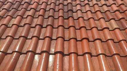 Clay Tile Roof Background. Overlapping Rows of Terracotta Tiles. Architectural Detail and Warm Color Palette