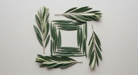 Green Leaves Arranged in a Geometric Square Pattern on a Light Gray Background