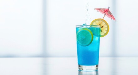 Blue Cocktail with Lemon Slices and Miniature Umbrella on Glass in Bright Environment