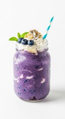 Blueberry Smoothie in Glass Jar with Whipped Cream Mint and Blue Straw on White Background