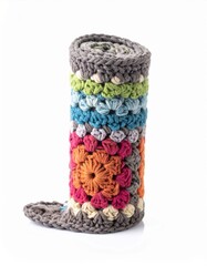 Rolled Up Colorful Crochet Blanket with Floral Motifs on White Background