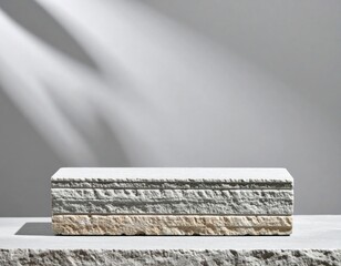 Textured Gray and Beige Stone Block Display in Soft Studio Lighting