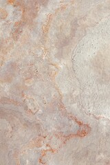 Natural stone texture with earthy tones of gray and rusty orange, showcasing rough surface patterns and organic details, ideal for backgrounds or design elements.