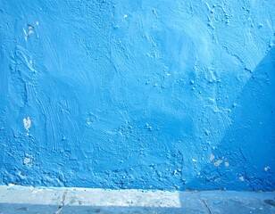A vibrant blue wall with texture and shadows